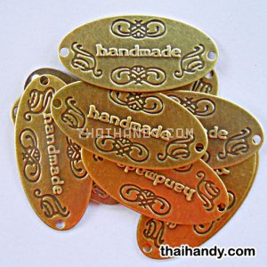 ป้ายโลหะ วงรี ขนาด 3x6 cm  บรรจุ 10 อัน สีทองรมดำ รูปเต็ม