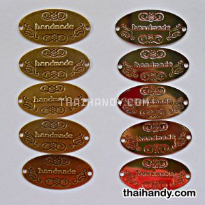 ป้ายโลหะ วงรี ขนาด 3x6 cm  บรรจุ 100 อัน สีคละสีเงินกับทองรมดำ รูปเต็ม